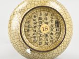 an image of a yellow and black vase with chinese writing on it