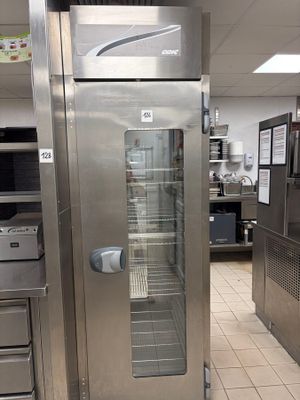 a stainless steel refrigerator in a commercial kitchen with a glass door