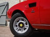 a red sports car parked in front of a brick building