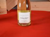 a bottle of wine sitting on a red table cloth