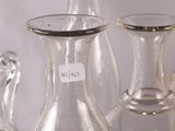 many glass vases sitting on a table with labels on them