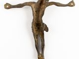 a close up of a bronze statue of a person on a cross