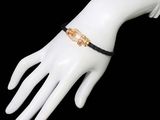 black and gold chain bracelet on a mannequin hand