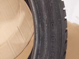 a close up of a tire on a cardboard box on a table