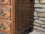 an old wooden chest of drawers sitting in front of a stone wall