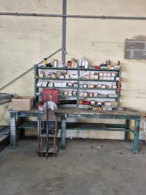 a workbench in a garage with many items on it