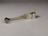 a silver spoon with a flower on it on a table