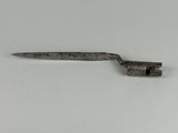 a small metal object on a white surface