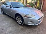 a picture of a silver sports car parked in a parking lot