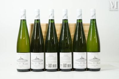 six bottles of wine are lined up in a row in front of a wooden box