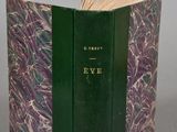 an open book with a green cover sitting on top of a table