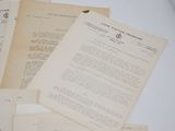 some old papers are piled on top of each other on a table