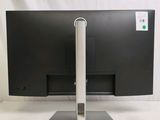 a computer monitor on a stand on a white surface