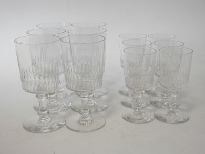 six clear wine glasses sitting on top of a white table