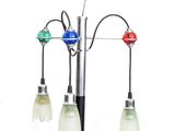 three lights that are attached to a pole on a white background