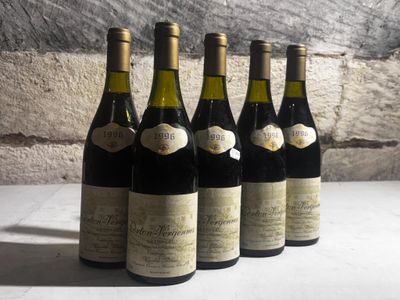 six bottles of wine are lined up on a table