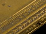 an image of a close up of a gold book with writing on it