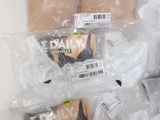 three packages of donuts wrapped in plastic on a counter