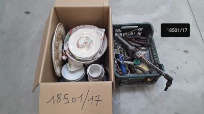 a cardboard box full of assorted items on the sidewalk