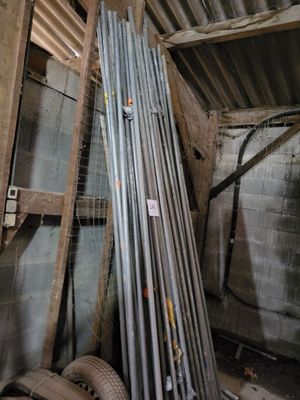 a pile of metal pipes stacked up in a room