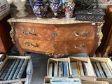 boxes of books and vases on a table in a room