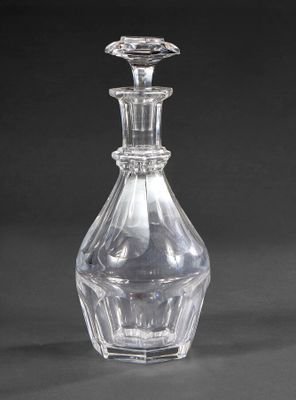 a clear glass bottle with a clear top on a black background
