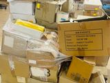 a pile of boxes sitting on a cart in a room