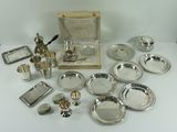 an assortment of silverplated items including a teapot, tray, and other items