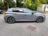 the grey car is parked on the side of the road