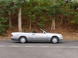 a silver convertible car parked on the side of the road