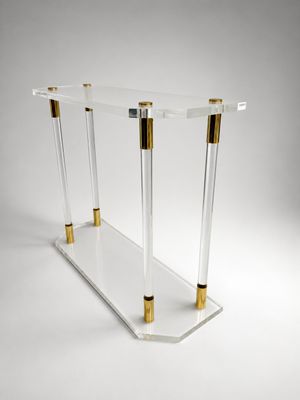a clear and gold console table with two gold legs