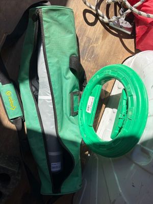 a green bag and a pair of scissors on a table