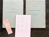 two books sitting on top of a table next to a piece of paper