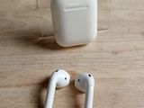 a pair of airpods sitting on a table next to a clear box