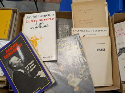 several books are stacked on top of each other in a box