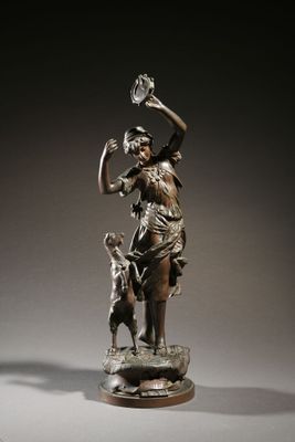 bronze statue of a woman with a dog and a clock