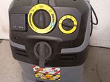 a machine that is sitting on the floor next to a hose