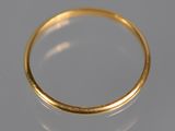 a close up of a gold ring on a white surface