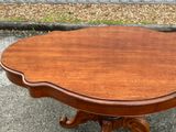 a wooden table that has a wooden top on it
