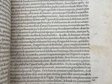 a close up of a book open to a page with a picture of a bird on it