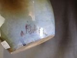a close up of a vase with a tag on it