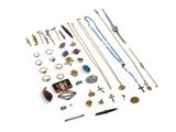 many different types of necklaces and bracelets on the table