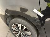 a close up of a black car with a sticker on it