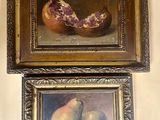 two framed paintings of pears and pears on a wall