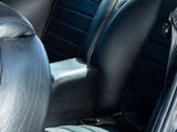 a close up of a black leather seat in a car