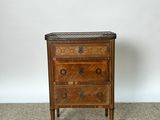 an antique wooden chest of drawers with a marble top
