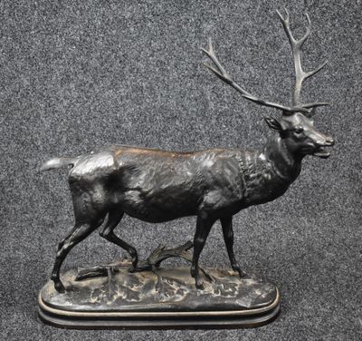 a statue of a deer that is standing on a base