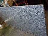 a piece of granite sitting on the floor in a room