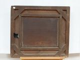 a small wooden box with a wooden frame on a stand