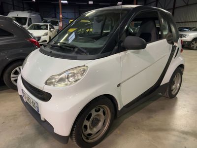 a small white car that is parked in a garage
